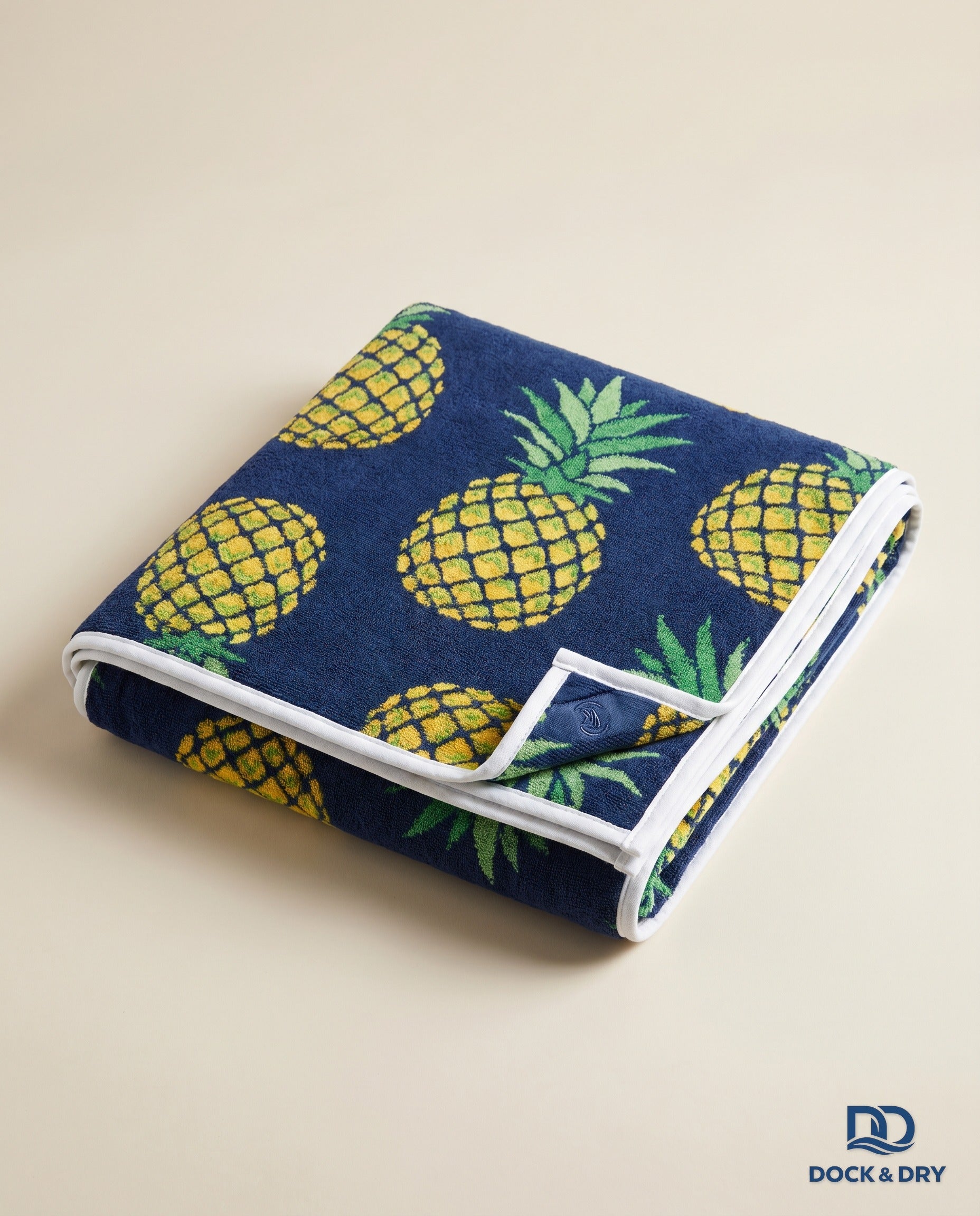 Dock & Dry magnetic beach towel – Pineapple, folded with corner magnets