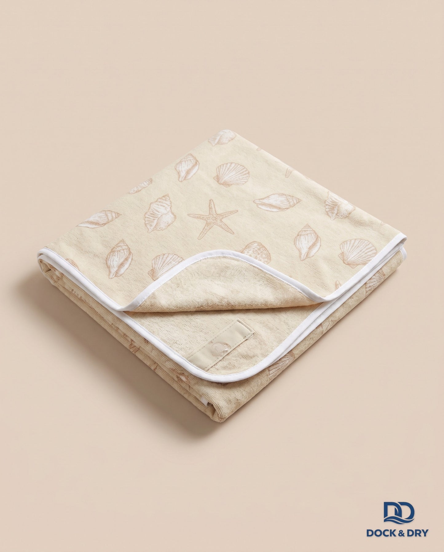 Dock & Dry magnetic beach towel – Seashells, folded with corner magnets