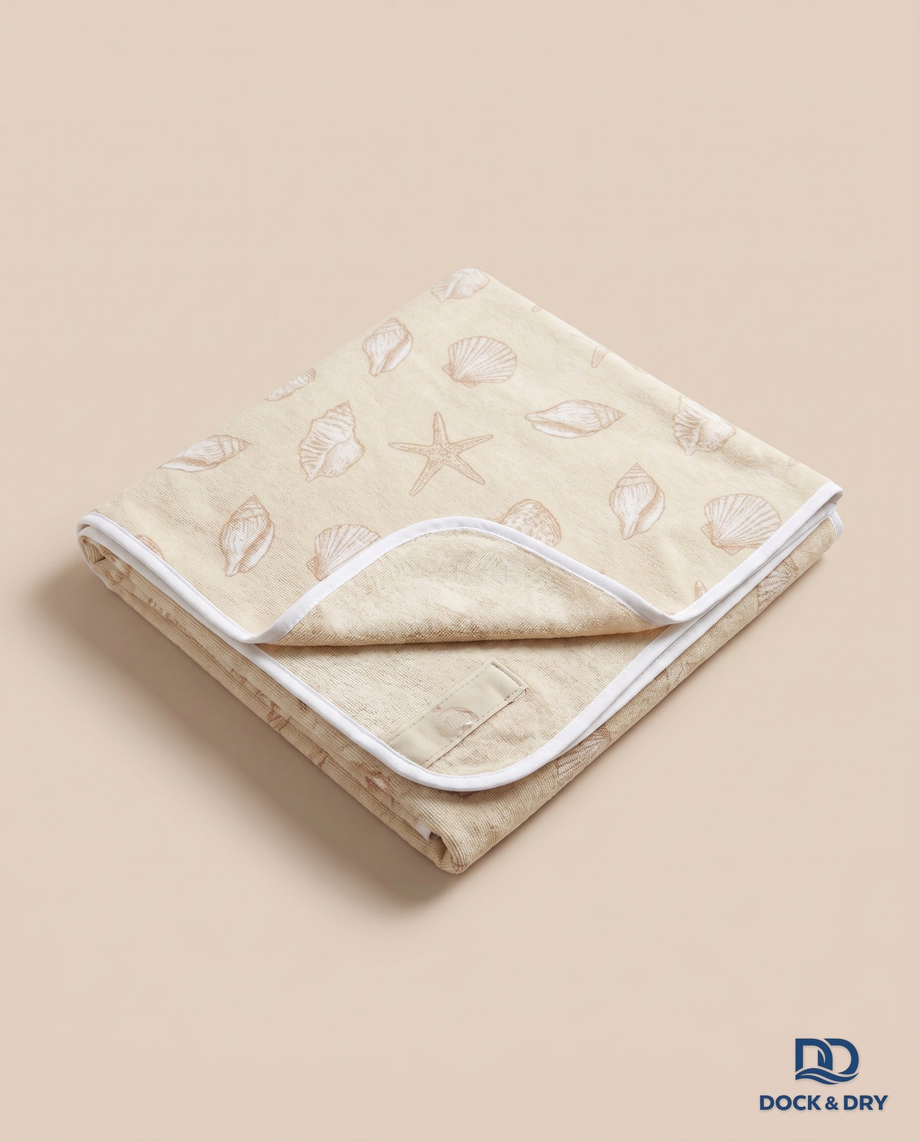 Dock & Dry magnetic beach towel – Seashells, folded with corner magnets
